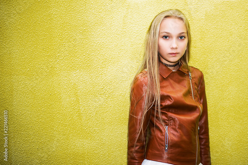 teenage girl on a yellow wall background photo