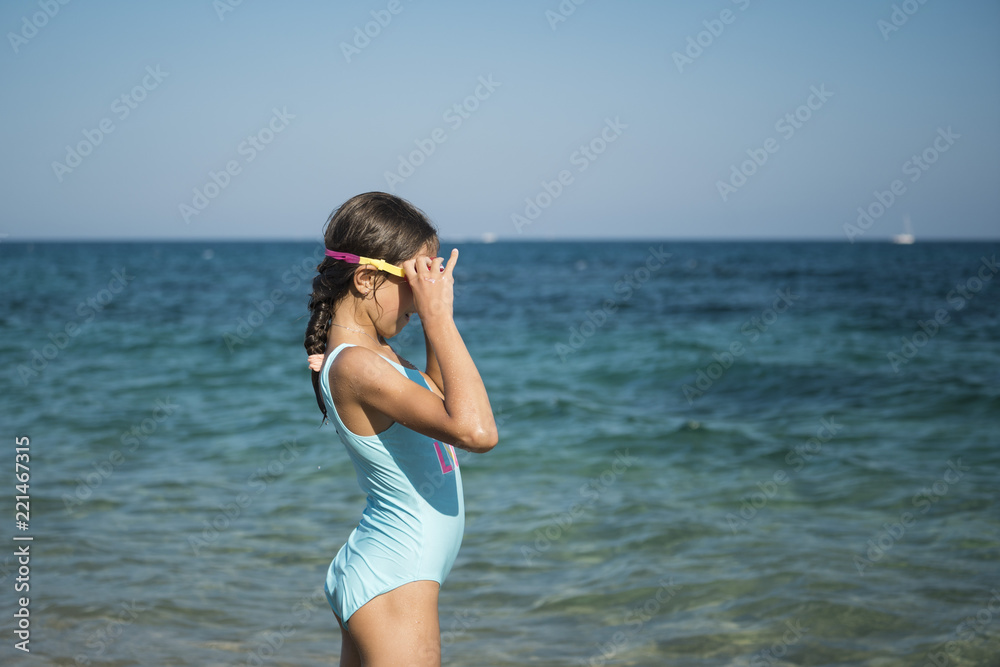 Teenager girl swims in the sea.