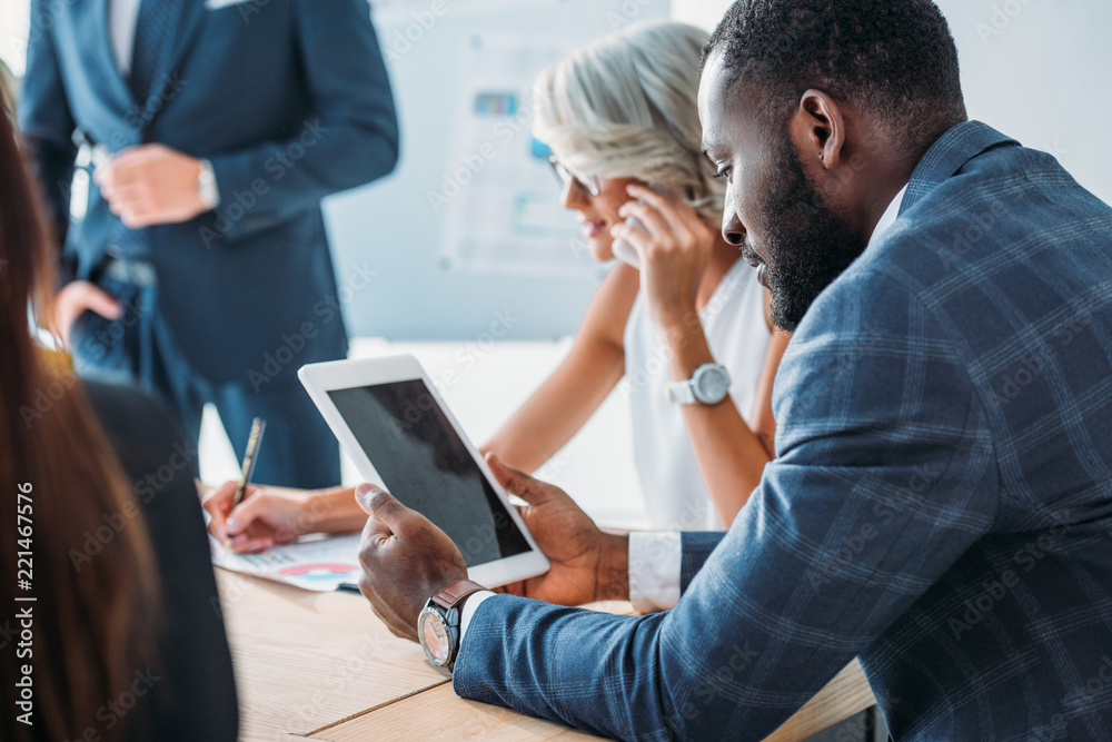 african american businessman using tablet with blank screen during meeting in office african american businessman using tablet with blank screen during meeting in office
