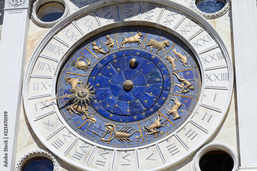 Saint Mark clock tower in Venice with gold zodiac signs in a sunny day in Italy