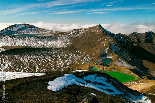 Alpine landscape of volcanic mountains in New Zealand's Taupo Volcanic Zone, Sceninc view from Red Crater To Blue Lake Tongariro Alpine Crossing, Emerald lakes and deep blue lake in distance