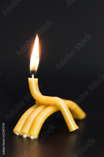 burning church candle on black background. man sitting on bench. Problem of loneliness, depression, sorrow, unrequited love, suicide. concept of social problems.