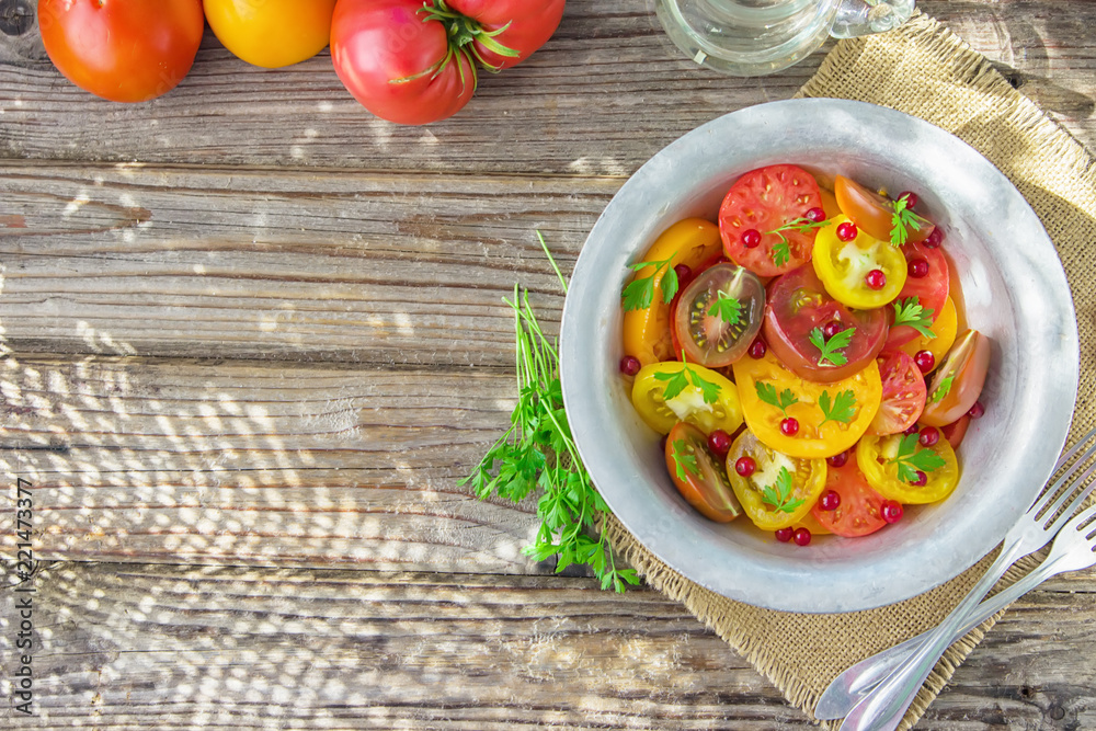 Tasty summer salad of sliced fresh colorful tomatoes, chopped red onion with white currant berries, olive oil, and parsley. Healthy meal Tasty summer salad of sliced fresh colorful tomatoes, chopped red onion with white currant berries, olive oil, and parsley. Healthy meal