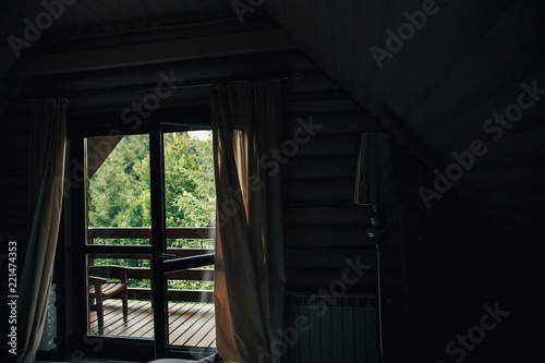 beautiful view from window on porch on trees in woods. cottage balcony with view on forest in mountains. atmospheric moment. summer vacation. rural country relax time