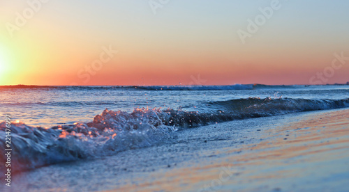 Sea sunset. Surf waves in the light of the setting sun