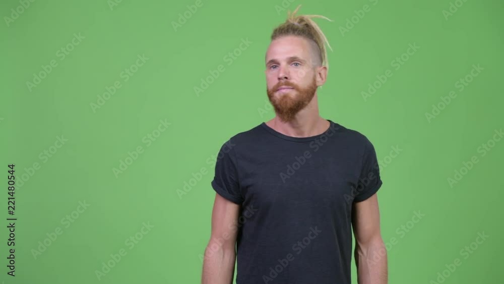 Handsome bearded man with dreadlocks thinking Handsome bearded man with dreadlocks thinking