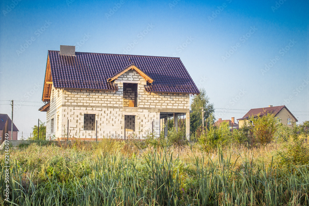 new house under construction stands on top of a hill new house under construction stands on top of a hill