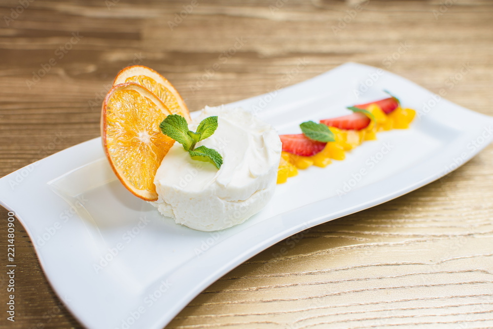 curd dessert with fruits and mint on a white plate curd dessert with fruits and mint on a white plate
