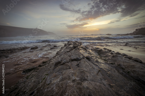 Santander, Sunset in Tagle beach. panoramic view of nice colorful huge cliff and sea on the back. Cantabria. Spain.