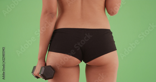 Butt of a hispanic woman working out on green screen