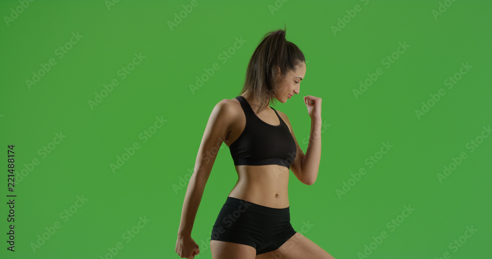 A Hispanic girl does a power pose on green screen A Hispanic girl does a power pose on green screen