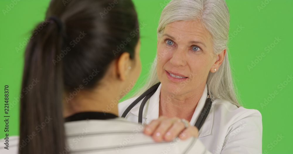 A happy doctor talks to a patient on green screen A happy doctor talks to a patient on green screen