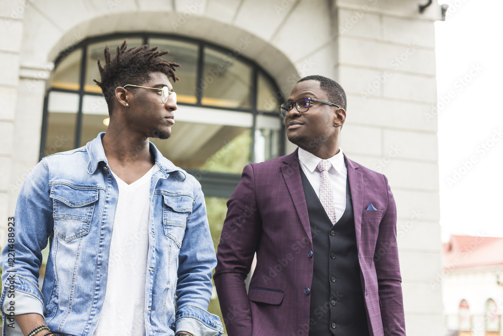 © xartproduction - two young and stylish African American men in the city smiling and talking. father and adult son relationship © xartproduction - two young and stylish African American men in the city smiling and talking. father and adult son relationship