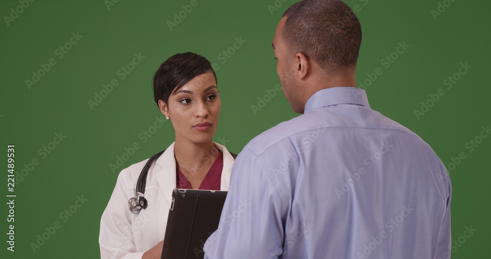 An African American doctor advises her patient on green screen An African American doctor advises her patient on green screen