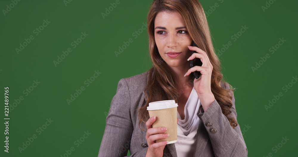 Young businesswoman talking on the phone with a client on green screen Young businesswoman talking on the phone with a client on green screen