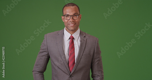 Obraz na plátně A black businessman poses for a portrait on green screen