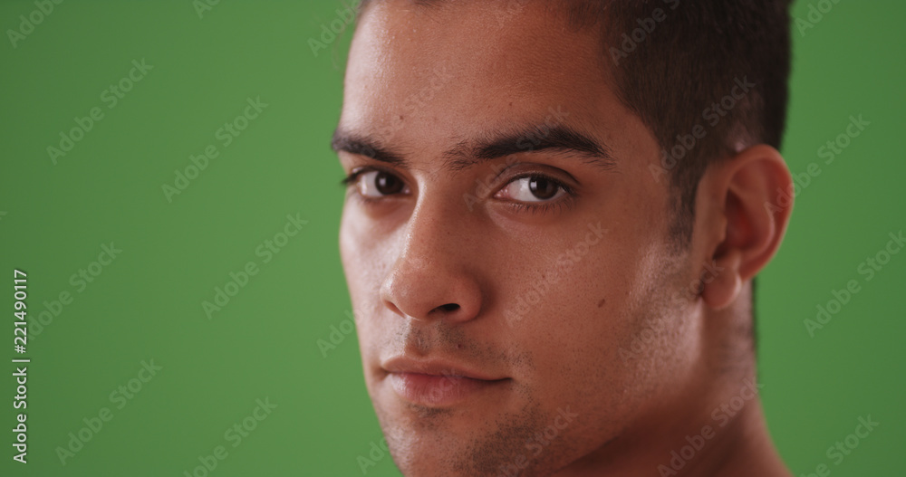 Close up portrait of handsome Hispanic man on green screen Close up portrait of handsome Hispanic man on green screen