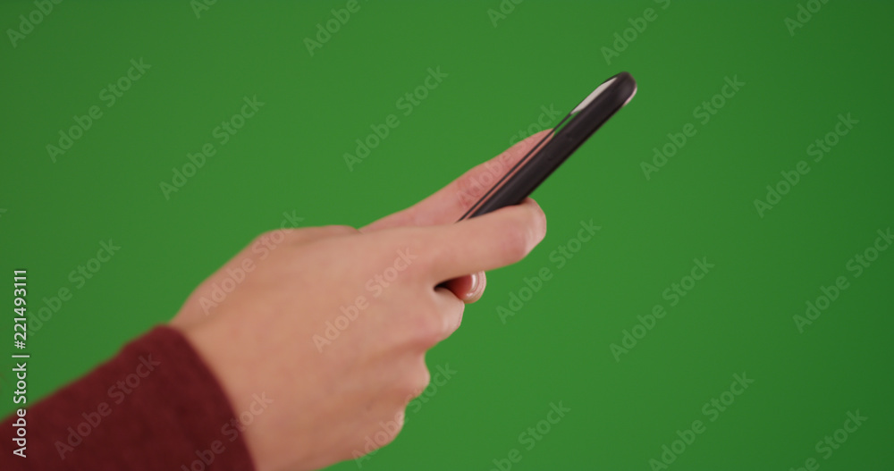Young Caucasian woman's hands messaging on cellphone on green screen Young Caucasian woman's hands messaging on cellphone on green screen