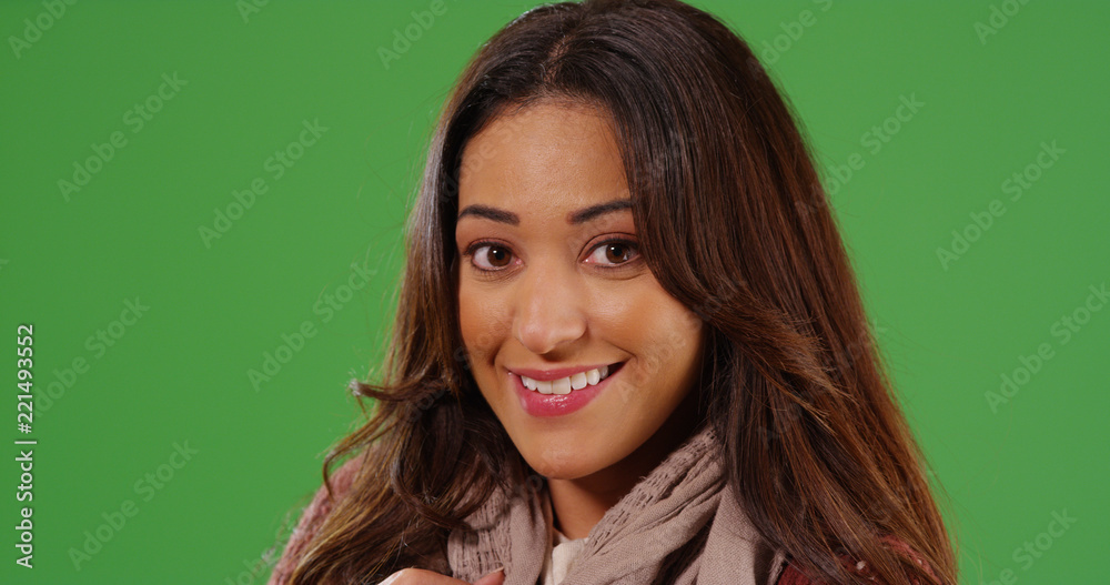 Close up of attractive Latina woman smiling warmly at camera on green screen Close up of attractive Latina woman smiling warmly at camera on green screen