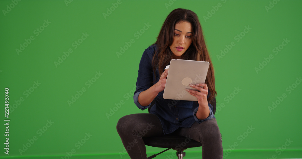 Portrait of woman holding coffee using pad device on green screen Portrait of woman holding coffee using pad device on green screen