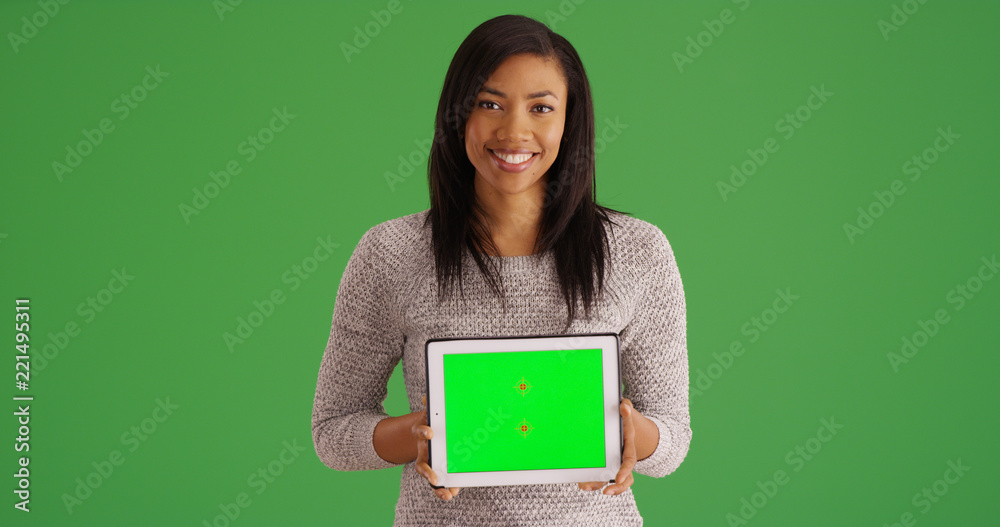 Smiling black woman holding tablet with green screen for custom content Smiling black woman holding tablet with green screen for custom content