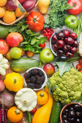 Healthy summer fruits vegetables berries background  cherries peaches strawberries cabbage broccoli cauliflower squash tomatoes carrots spring onions beans beetroot  pepper  top view  vertical