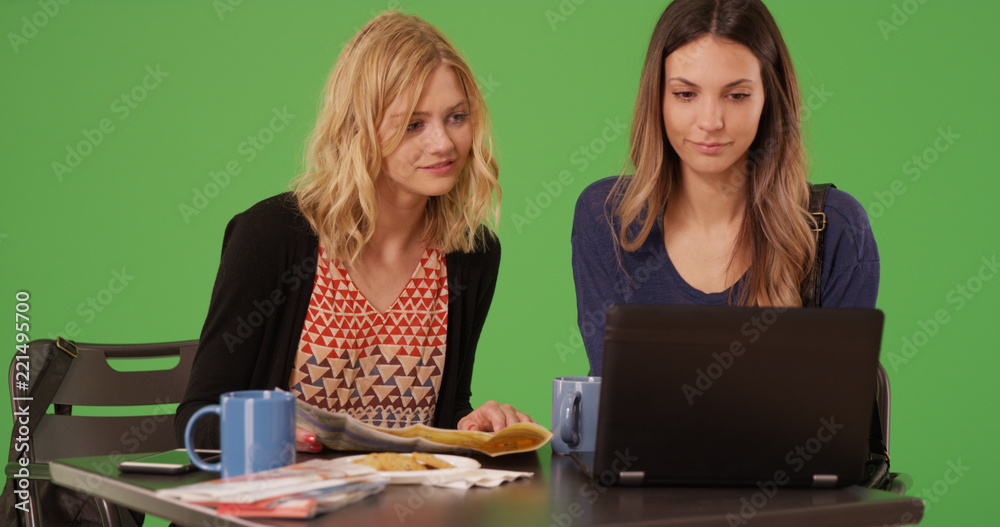 White women tourists getting directions with map and laptop on green screen White women tourists getting directions with map and laptop on green screen