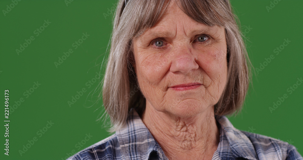 Closeup of serious white woman looking at camera on green screen Closeup of serious white woman looking at camera on green screen