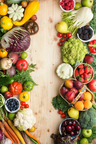 Fototapeta Naklejka Na Ścianę i Meble -  Fresh organic fruits vegetables berries, cherries apricots strawberries cabbage broccoli cauliflower squash tomatoes carrots spring onions beans beetroot, pepper, copy space, top view, vertical