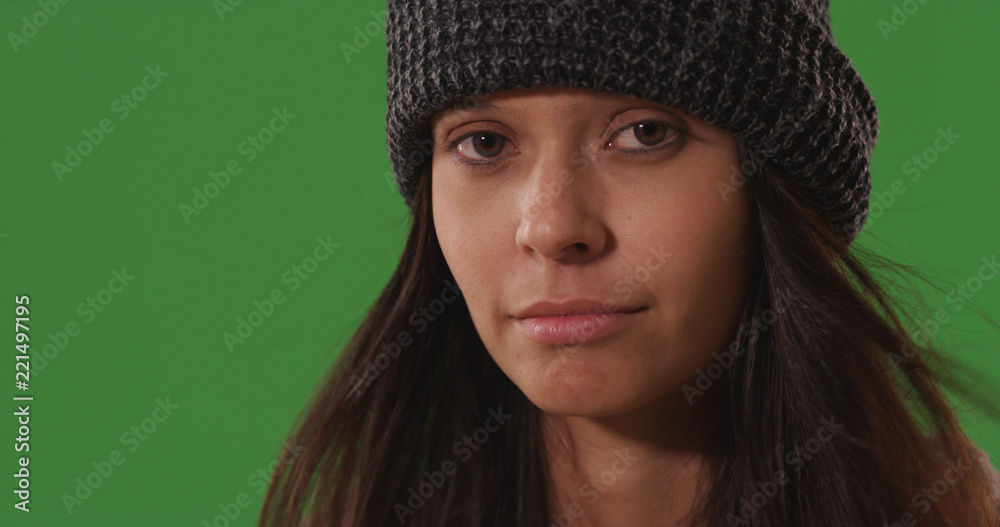 Brunette millennial female looking at camera posing on green screen Brunette millennial female looking at camera posing on green screen