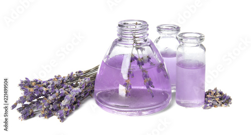 Fototapeta Naklejka Na Ścianę i Meble -  Bottles with aromatic lavender oil on white background