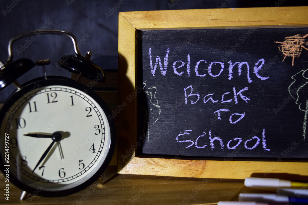 Welcome back to school message concept with quote written on chalkboard. Welcome back to school message concept with quote written on chalkboard.