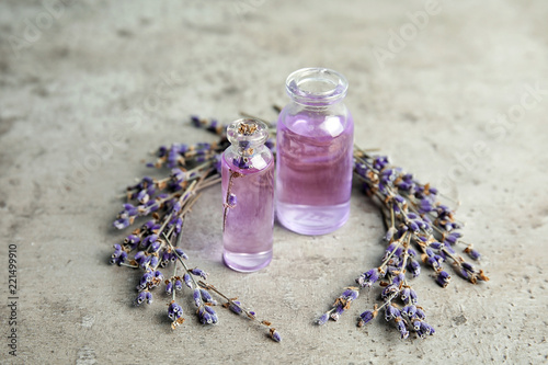 Fototapeta Naklejka Na Ścianę i Meble -  Natural herbal oil in glass bottles and lavender flowers on color background