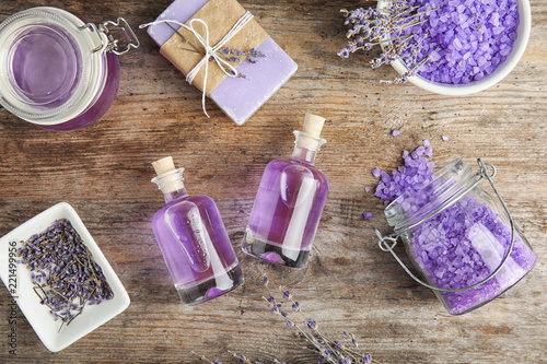 Fototapeta Naklejka Na Ścianę i Meble -  Flat lay composition with natural herbal oil and lavender flowers on wooden background
