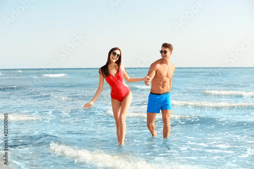 Happy young couple having fun at beach on sunny day © New Africa