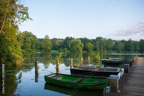 Fototapeta Naklejka Na Ścianę i Meble -  Lake with jetty and old rowboats. Location: Germany, North Rhine Westphalia, Hoxfeld