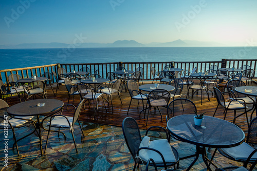 Early Summer Morning on the Wooden Terrace with View of the Calm Sea and Distant Mountains