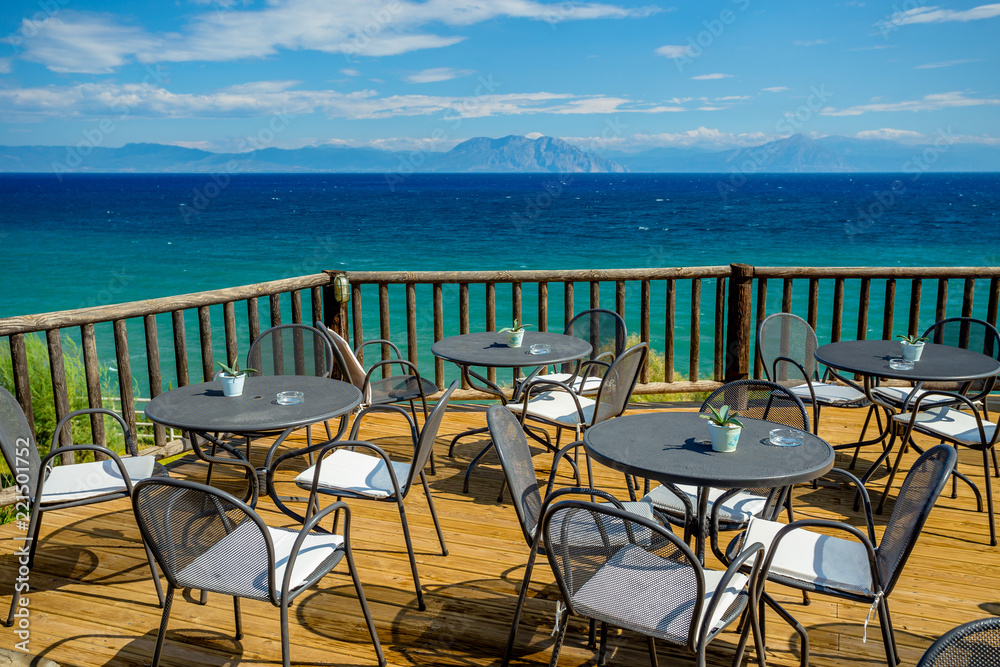 Bright Sunny Afternoon on the Wooden Terrace with View of the Turquoise Mediterranean Sea and Distant Mountains