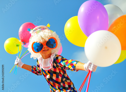 funny kid clown with balloons