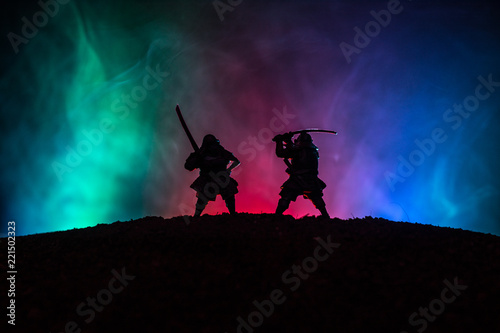 Silhouette of two samurais in duel. Picture with two samurais and sunset sky