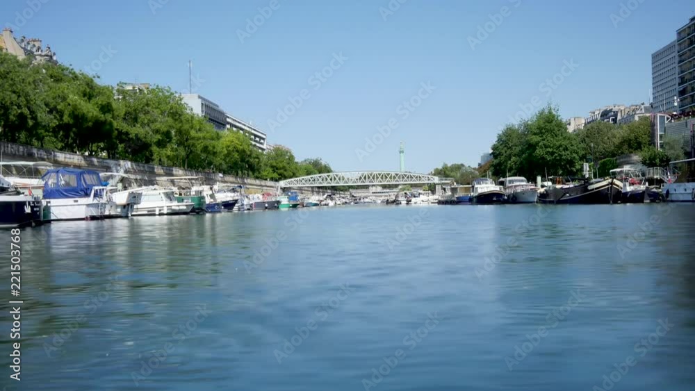 Time lapse of the Bassin de l'Arsenal (also known as the Port de l'Arsenal) in Paris. It is a boat basin in Paris. Filmed in summer. Time lapse of the Bassin de l'Arsenal (also known as the Port de l'Arsenal) in Paris. It is a boat basin in Paris. Filmed in summer.