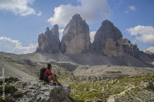 Young active hiker tourist man walking/hiking Tre Cime di Lavaredo trail in Dolomites, Italy, Europe. Beautiful mountain scenic landscape view. Summer outdoor activity or active holiday concept.