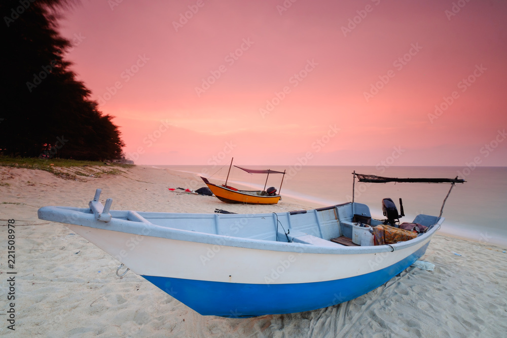 Fishing boats  is parked on the beach during beautiful sunset  at Kampung Mangkuk, Terengganu, Malaysia