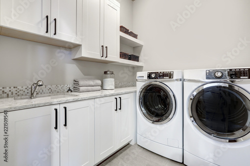 White clean modern laundry room with washer and dryer