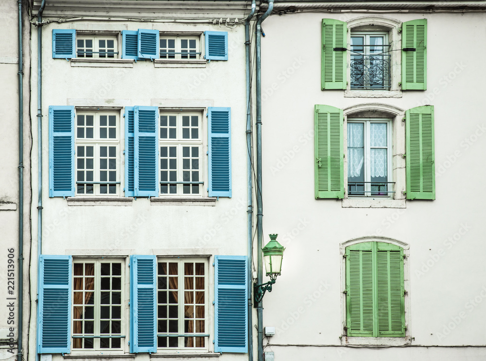 Colorful pattern of window panes and shutters on old building in Europe Colorful pattern of window panes and shutters on old building in Europe