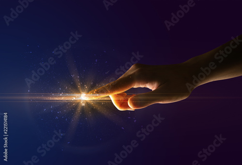 Female finger touching a beam of light
