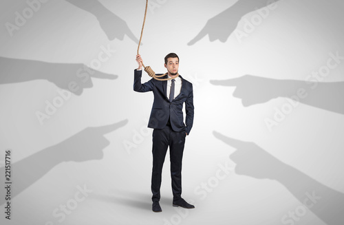 Young businessman trying to suicide with pointing hands concept
 photo