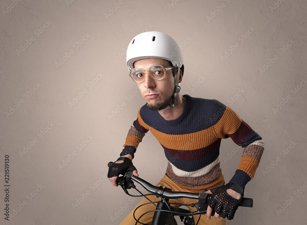 Nerd young foolish biker on a bike with oldschool outfit Stock-Foto | Adobe  Stock