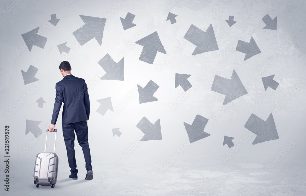 Obraz premium Businessman with back walking away with higgledy-piggledy arrows around 