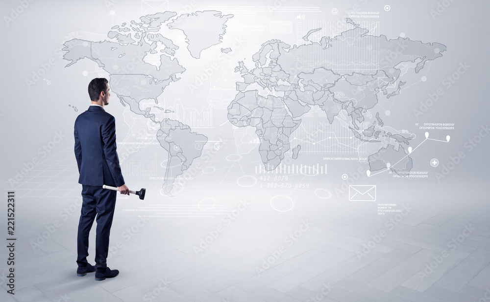 Businessman standing with his back and looking at a worldwide map with objects in his hand
Businessman standing with his back and looking at a worldwide map with objects in his hand